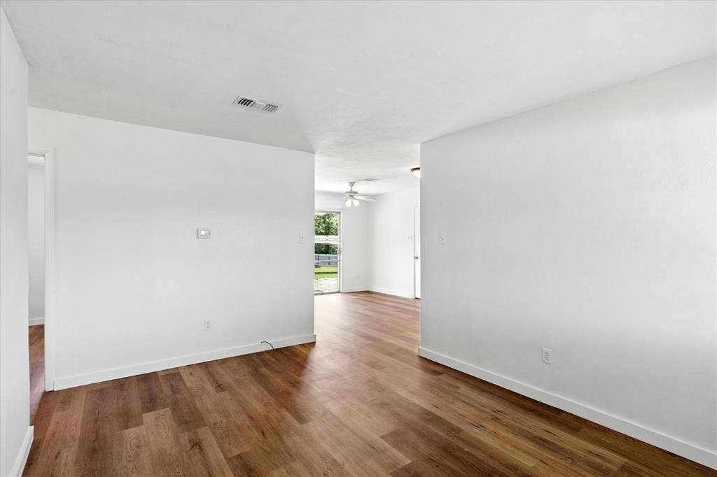 5820 Shipp Drive, Watauga, TX 76148 Open living area featuring wood-finish flooring, white walls, and white baseboards