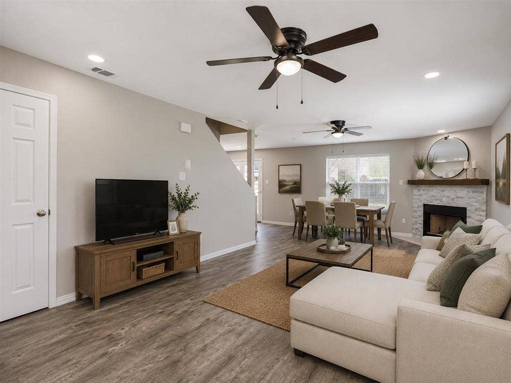 AI enhanced Spacious living area featuring wood-finish flooring, recessed lighting, and ceiling fans