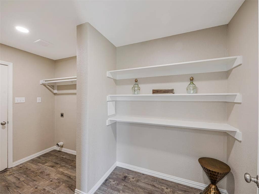 Dedicated laundry area featuring stainless steel appliances