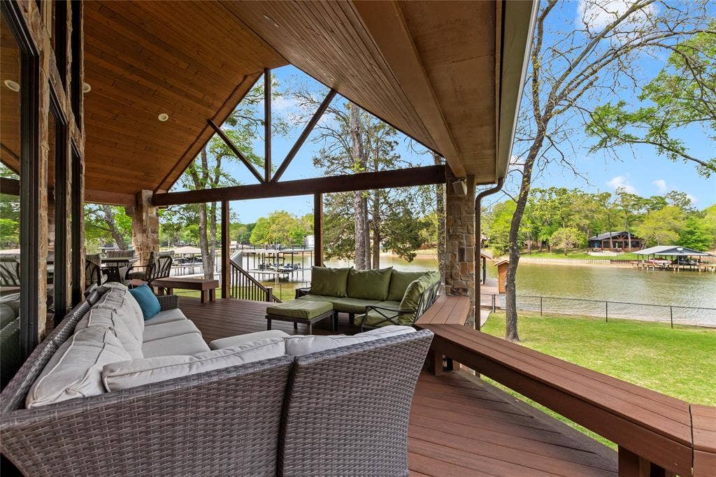 122 Lake Terrace Drive, Mabank, TX 75156 Covered porch overlooking fenced yard and lake views.