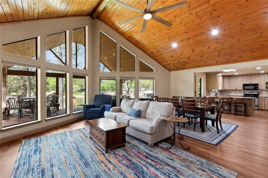 122 Lake Terrace Drive, Mabank, TX 75156 Living area with vaulted pine ceiling. Open-concept layout connecting main living areas.