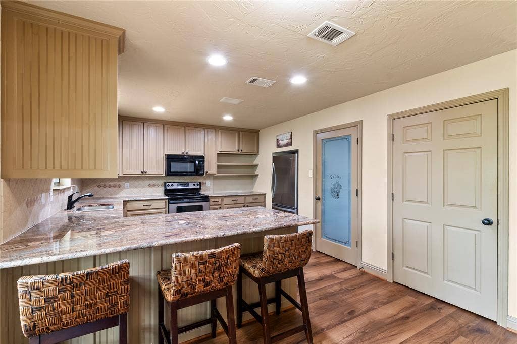 122 Lake Terrace Drive, Mabank, TX 75156 Pantry storage available in kitchen plus behind the solid door is an extra refrigerator.