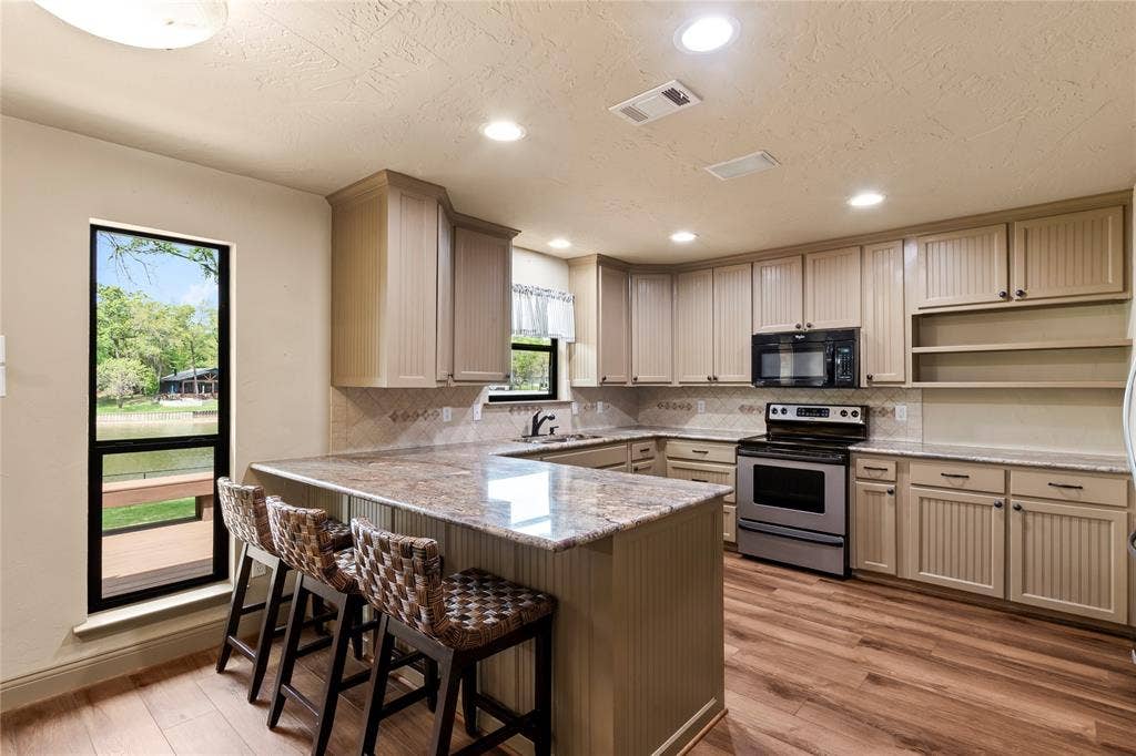 122 Lake Terrace Drive, Mabank, TX 75156 Kitchen with granite countertops and bar seating.