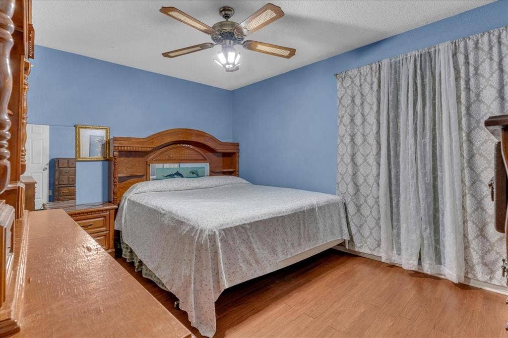 905 SE 3rd Street, Grand Prairie, TX 75051 Bedroom featuring ceiling fan and light wood-style floors