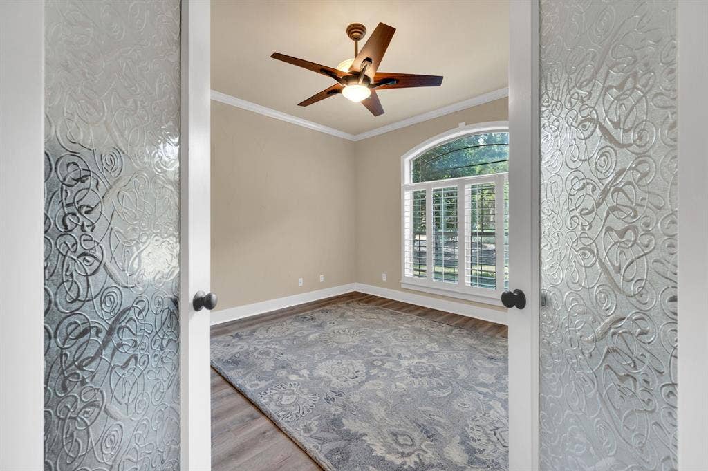 Entry view to flex room with decorative glass doors and open feel.