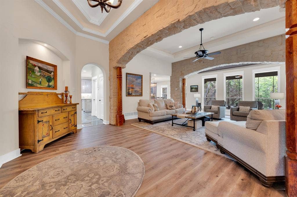 Grand foyer with arched doorways and Luxury Vinyl Plank flooring.