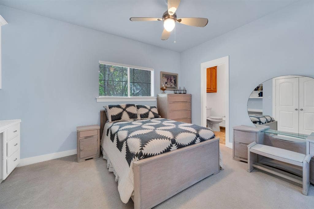 Guest bedroom with ensuite bath access and neutral tones.