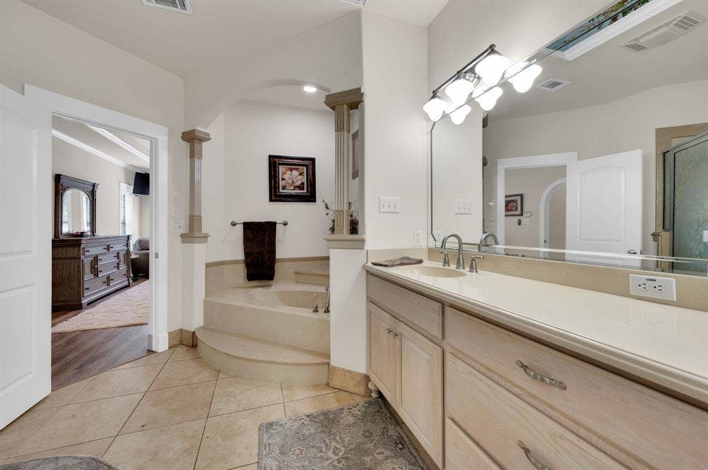 Secondary angle of primary bath highlighting dual sinks and open layout.