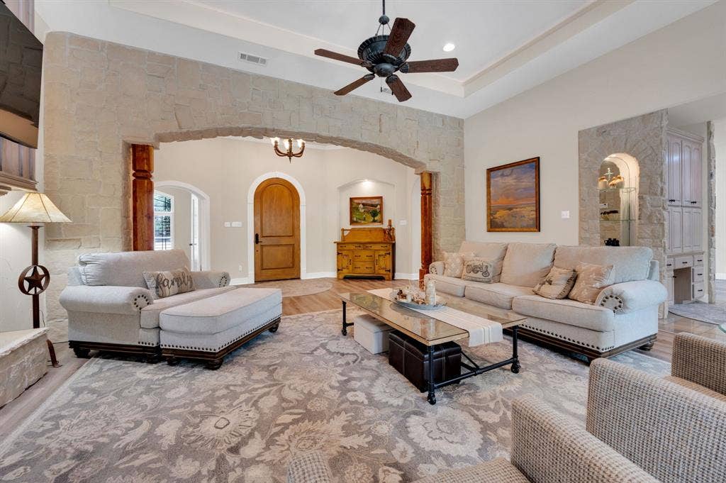 Spacious living room with vaulted ceiling and large windows