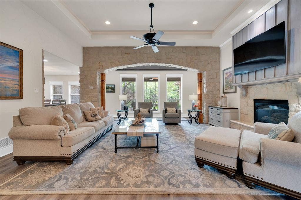 Living room showcasing architectural stone arch and wood beams