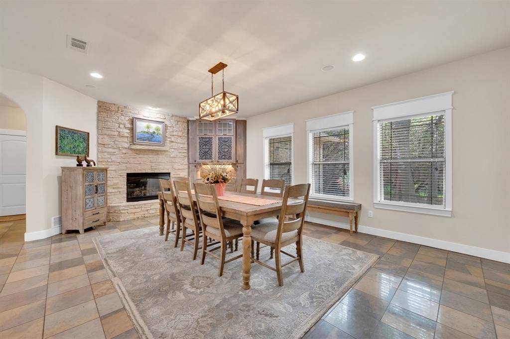 Dining area with stone fireplace and built-in cabinetry