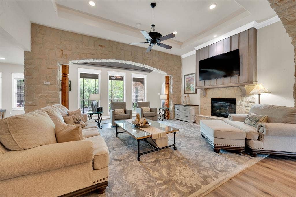 Living room with stone fireplace and beautiful archways