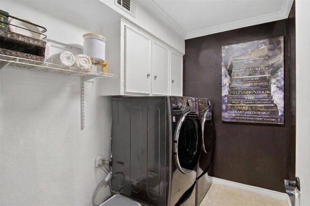 Laundry room featuring cabinet space, washing machine and dryer
