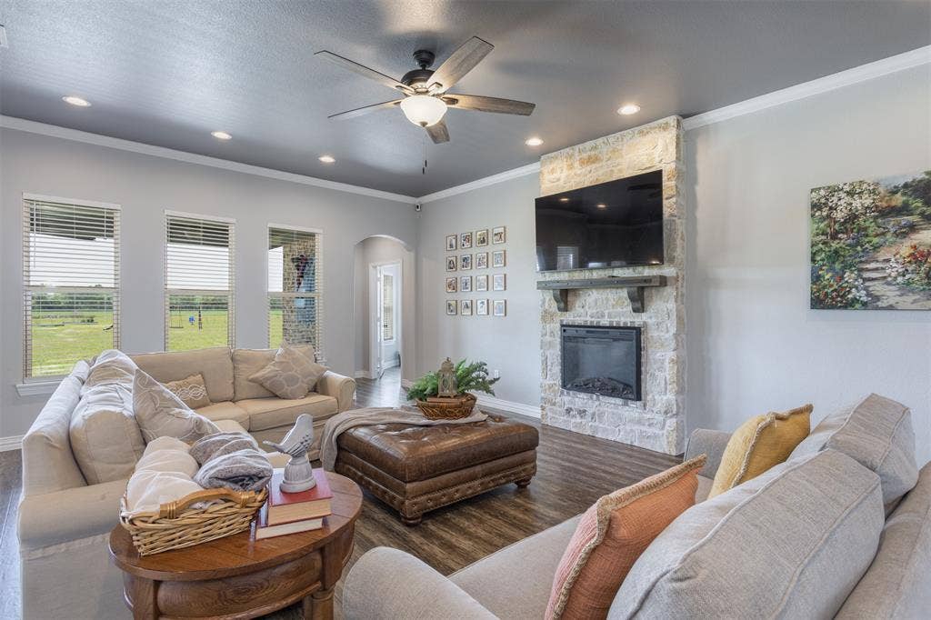 1538 Fm 36 N, Farmersville, TX 75442 Light and bright, comfy and warming, this family room is anchored by the electric fireplace. LVP flooring is carried throughout the primary living spaces.
