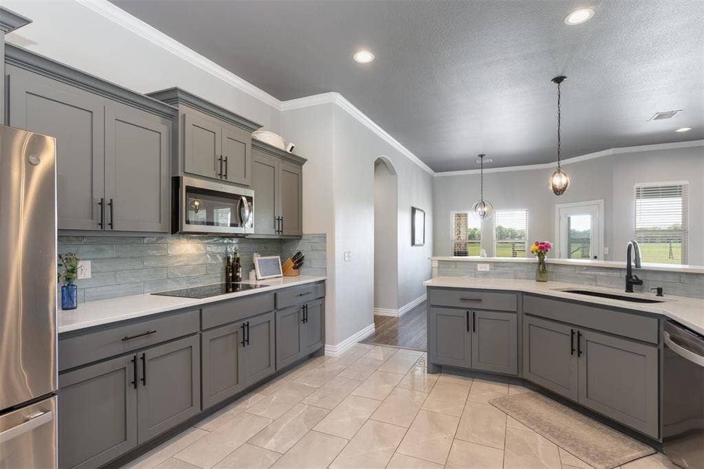 1538 Fm 36 N, Farmersville, TX 75442 Enjoy the backyard view from the kitchen. Large windows across the back of the home provide views for all.