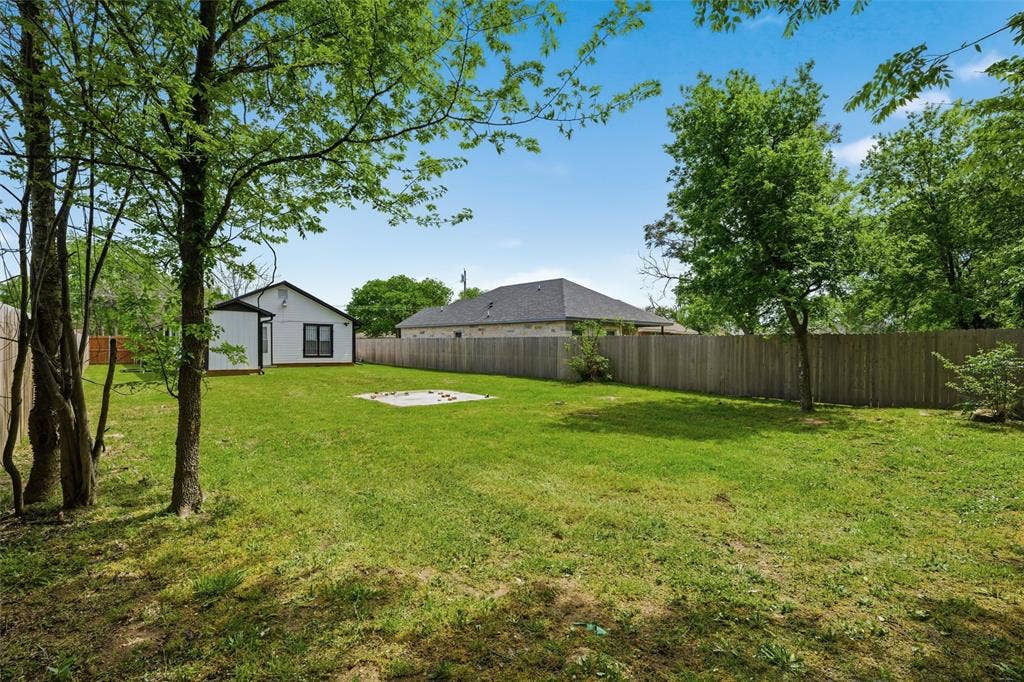 1116 Houston Street, Waco, TX 76704 Fenced backyard with an outbuilding