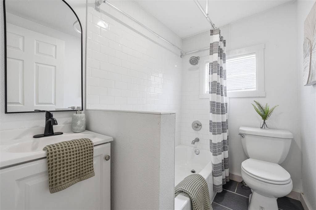 1116 Houston Street, Waco, TX 76704 Bathroom with shower / tub combo with curtain and vanity