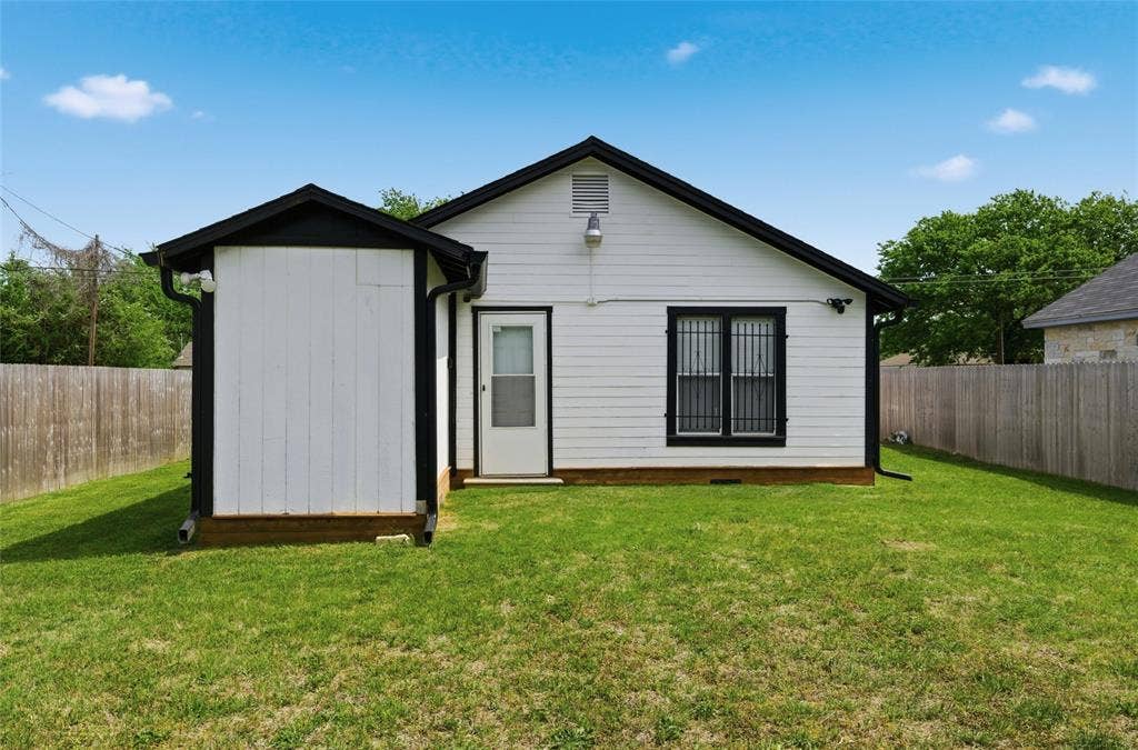 1116 Houston Street, Waco, TX 76704 Rear view of house featuring a fenced backyard