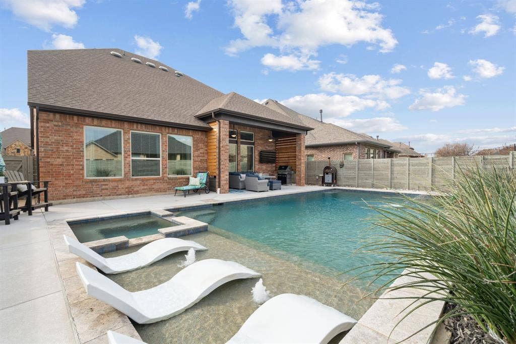 1104 9th Street, Argyle, TX 76226 Backyard dreams! Gorgeous salt water pool, spa and cozy covered seating area! Fully turfed backyard!