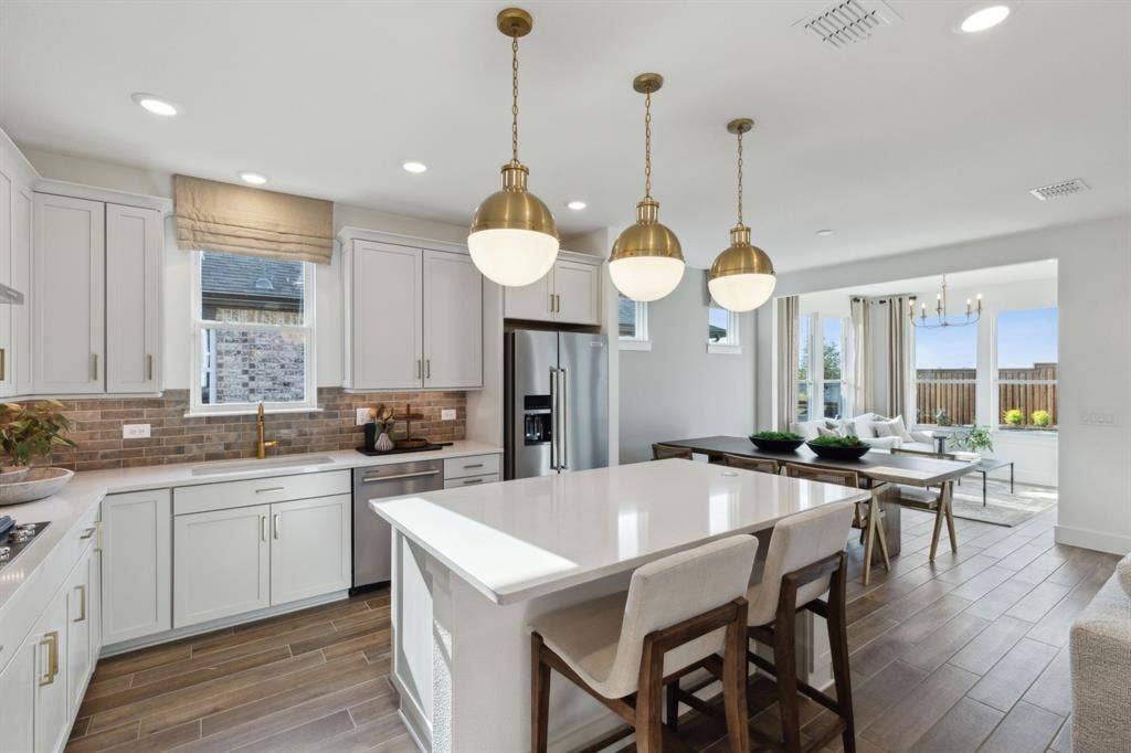 *Model Representation - Large island overlooking gathering room and dining areas
