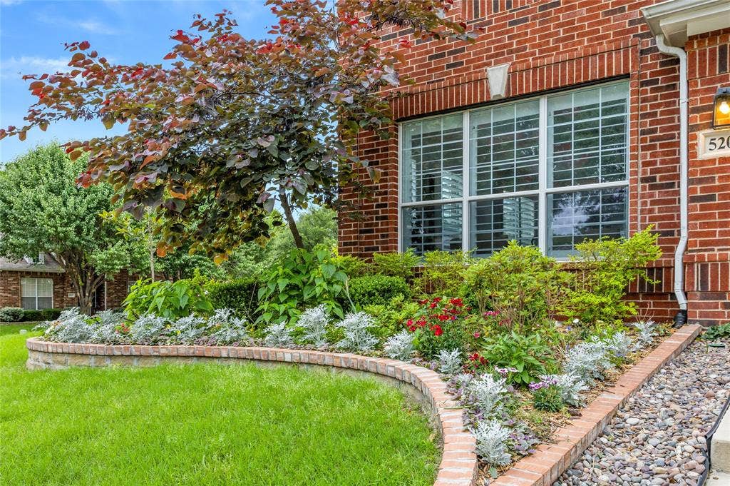 5201 Geode Lane, McKinney, TX 75072 Owner put in thousands of dollars in landscaping and hardscaping with stone borders/edging. All kinds of perennials, bushes and trees around property. It is absolutely beautiful. This picture was early spring, now plants are much bigger and flourishing. Must see!