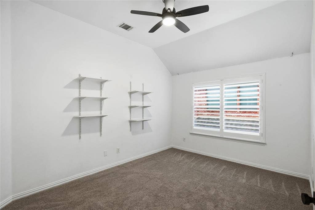 5201 Geode Lane, McKinney, TX 75072 Another view of spare bedroom with wall shelves. Great size secondary bedrooms..