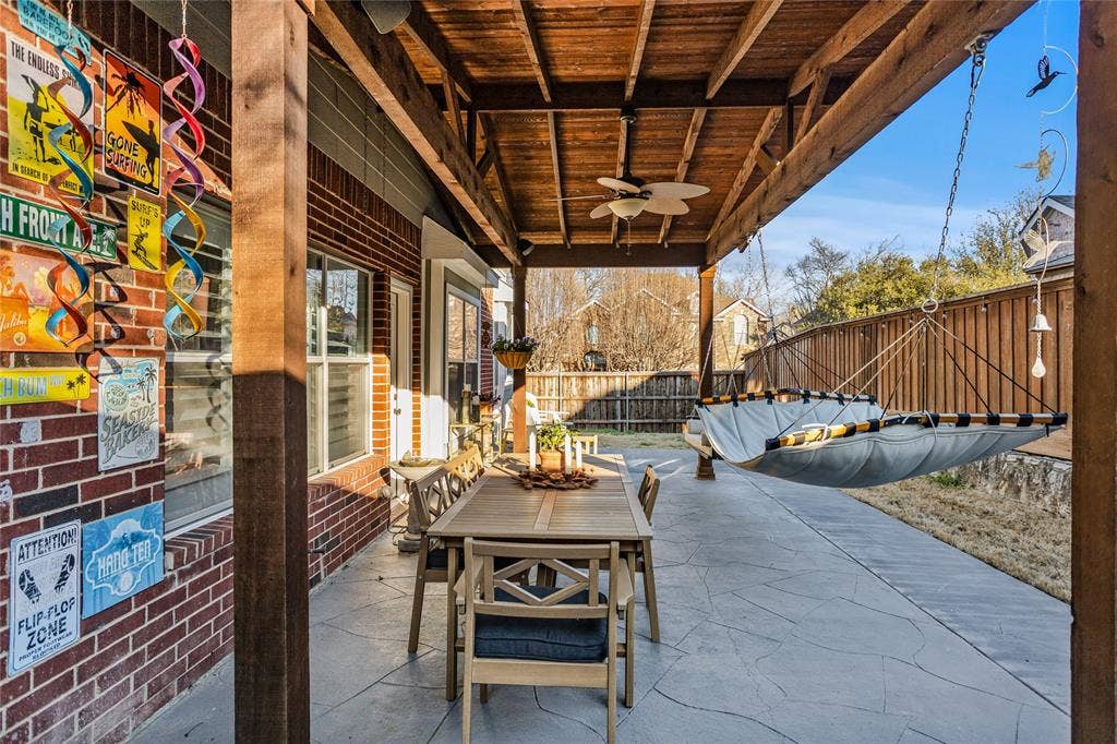 5201 Geode Lane, McKinney, TX 75072 Expanded wood covered patio. Lots of room for entertaining. The swing, hammock, chair and ottoman stay!