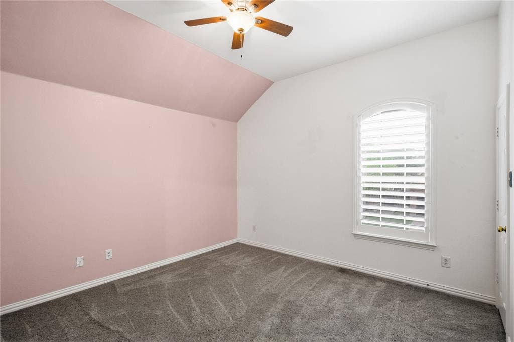 5201 Geode Lane, McKinney, TX 75072 Good size secondary bedroom with vaulted ceilings and pretty blush colored accent wall.