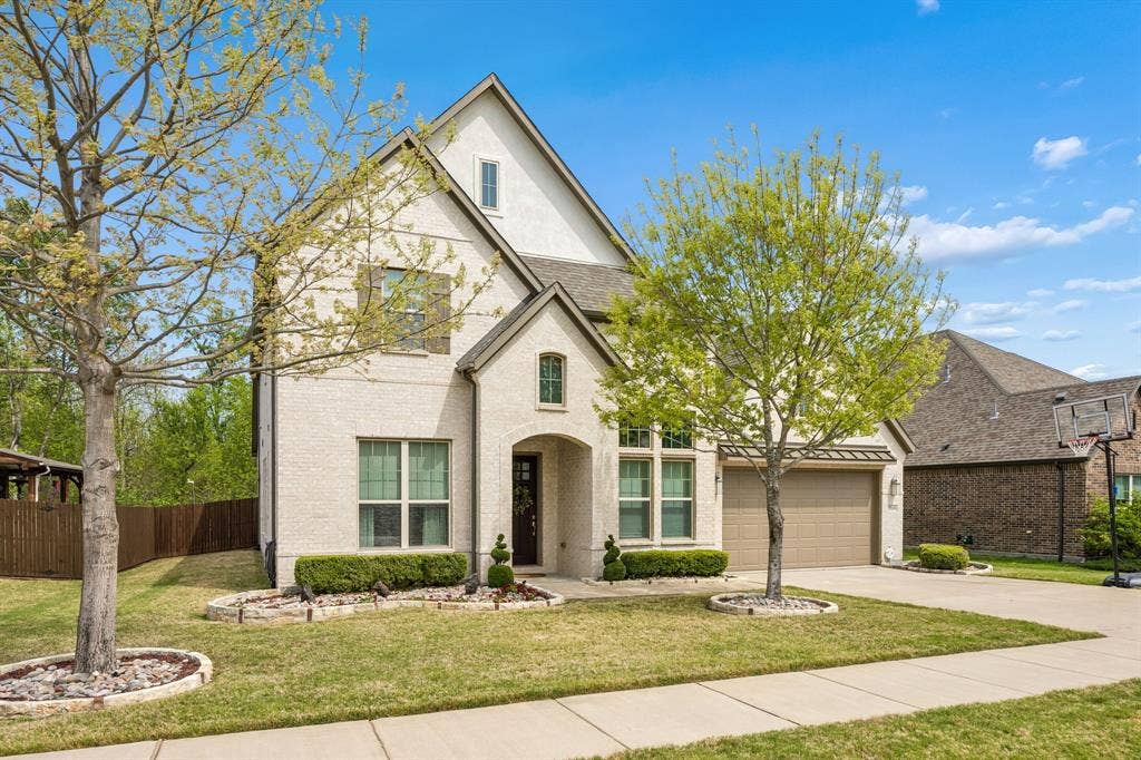 Stunning two-story traditional home where exceptional curb appeal with sophisticcated architectural details. Dramatic high-pitched gables with a grand arched entryway which accents the rich wood 8 foot front door.  3 CAR tandem garage.