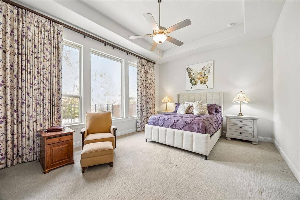 Primary bedroom layout easily accomodates a king bed and features a sitting area alongside the wall of windows framing peaceful and private views.
