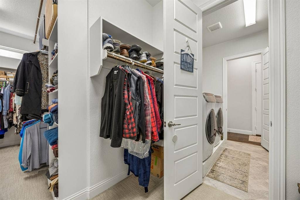 Massive primary closet has direct access to the dedicated laundry room which opens into the mud room just off of the garage entry.