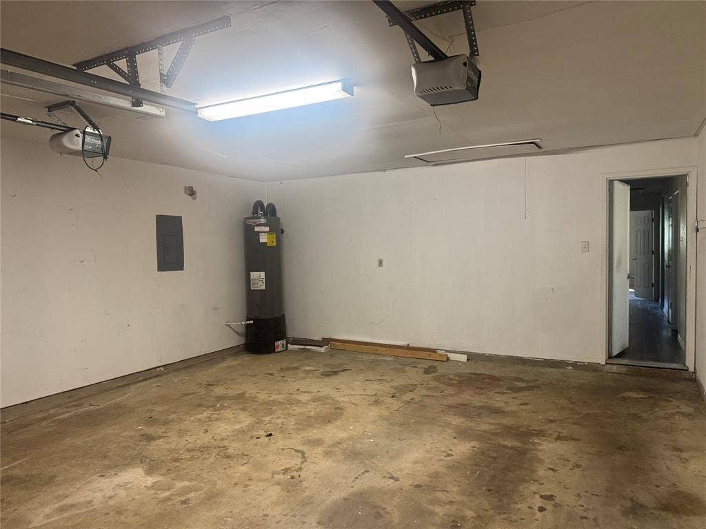 2301 Holly Drive, Euless, TX 76039 Spacious garage featuring a concrete floor, white walls, and fluorescent lighting