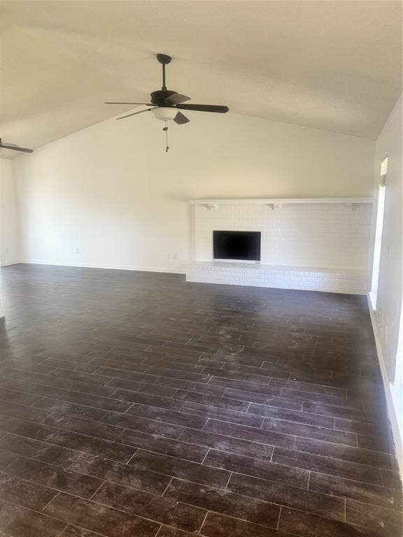 2301 Holly Drive, Euless, TX 76039 Spacious room featuring dark wood-finish tile flooring and a vaulted ceiling with a ceiling fan