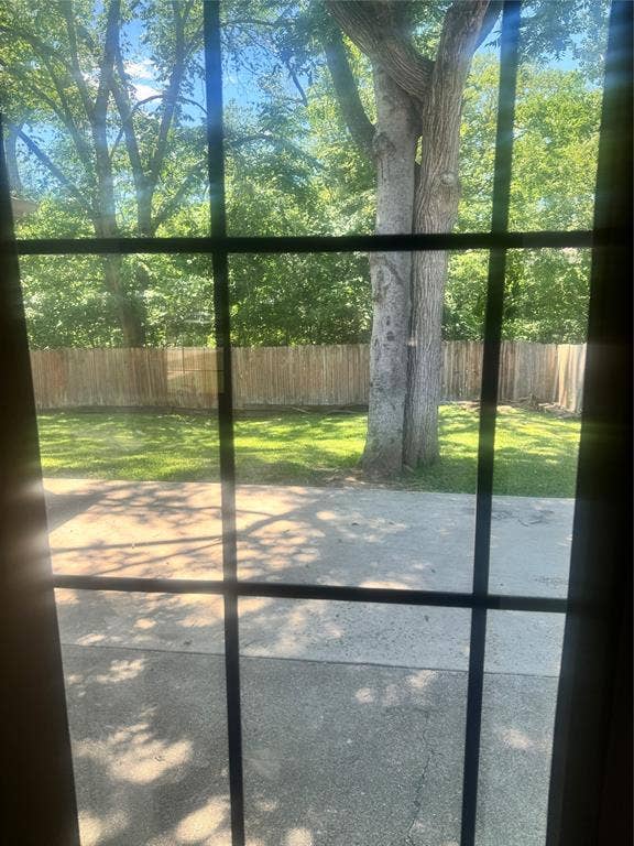 2301 Holly Drive, Euless, TX 76039 Expansive backyard featuring a mature tree, manicured lawn, and privacy fencing