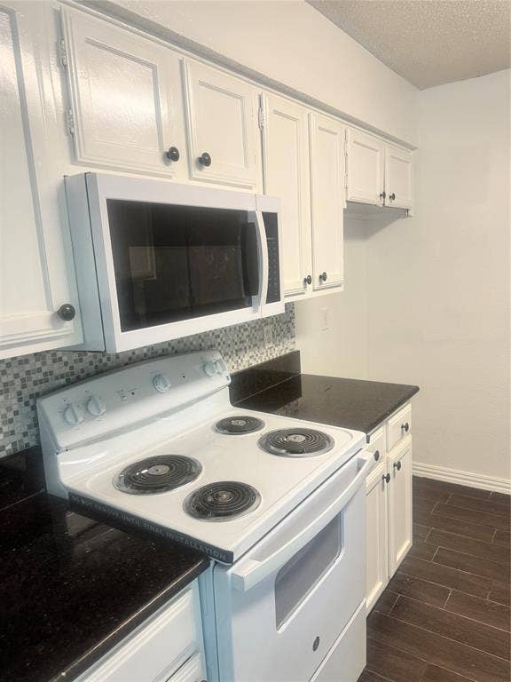 2301 Holly Drive, Euless, TX 76039 Kitchen featuring white cabinetry, dark countertops, a mosaic tile backsplash, a white electric range, and a white over-the-range microwave