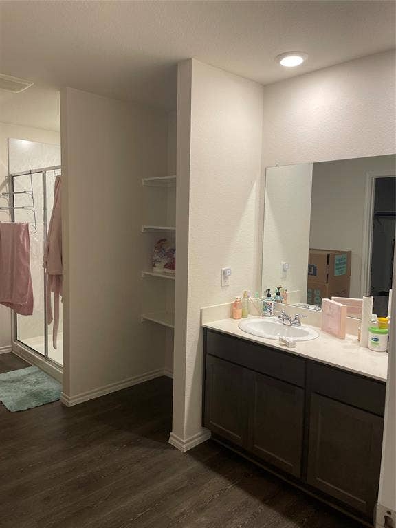 468 Unbridled Road, Waxahachie, TX 75165 Full bathroom with vanity, a stall shower, and dark wood-style flooring