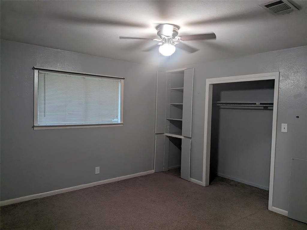 2009 County Road 4619, Athens, TX 75752 Unfurnished bedroom with light carpet, ceiling fan, and a closet