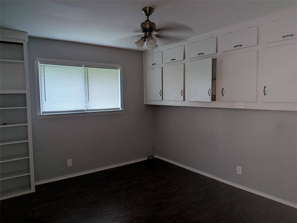 2009 County Road 4619, Athens, TX 75752 Unfurnished room featuring a ceiling fan and dark wood-type flooring