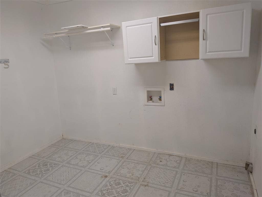 2009 County Road 4619, Athens, TX 75752 Laundry room with washer hookup, cabinet space, and light flooring