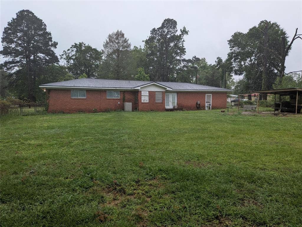 2009 County Road 4619, Athens, TX 75752 View of front of property with brick siding and view of wooded area