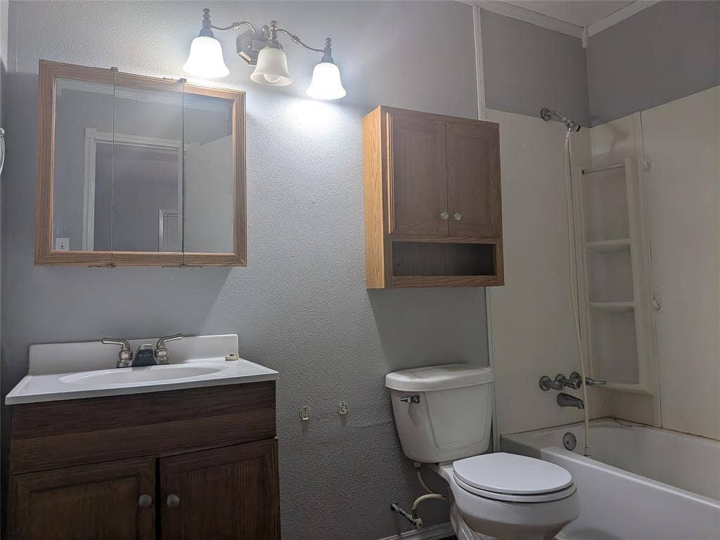 2009 County Road 4619, Athens, TX 75752 Bathroom featuring vanity, shower / bath combination, and a textured wall