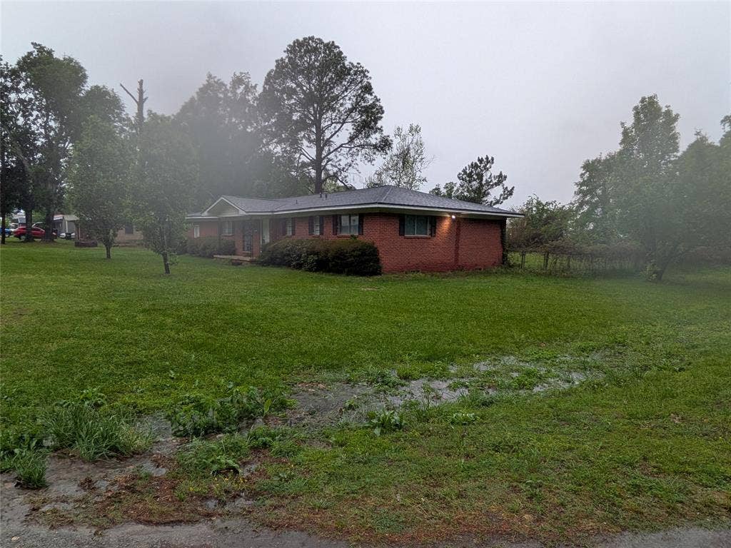 2009 County Road 4619, Athens, TX 75752 View of side of property with a lawn and brick siding