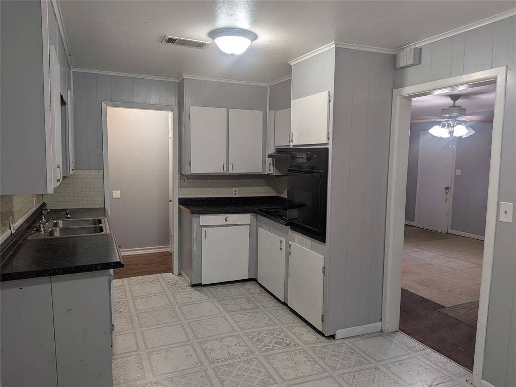 2009 County Road 4619, Athens, TX 75752 Kitchen featuring white cabinets, dark countertops, oven, ceiling fan, and light flooring