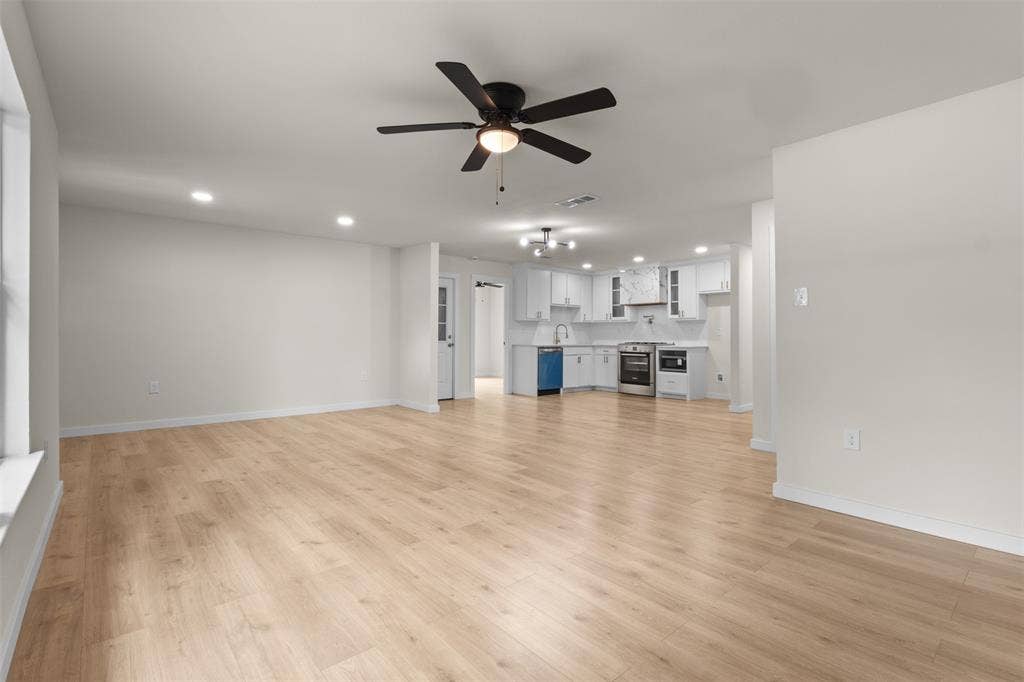 425 Browning Drive, Arlington, TX 76010 Spacious interior featuring light wood-finish flooring, recessed lighting, and a dark ceiling fan