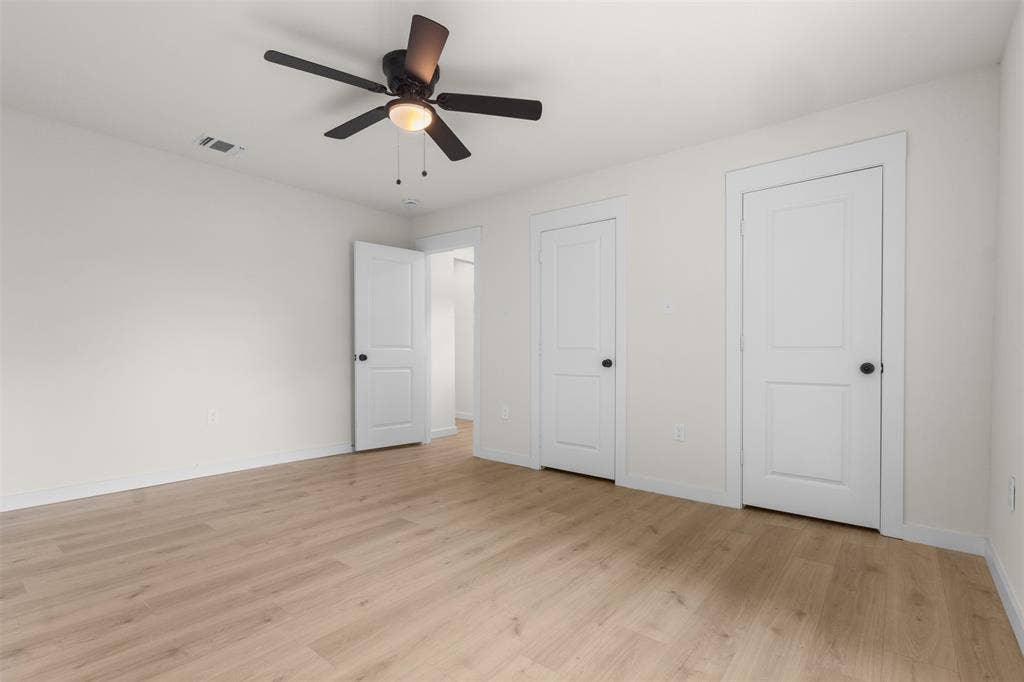 425 Browning Drive, Arlington, TX 76010 Bright interior space featuring wood-finish flooring and a ceiling fan with integrated lighting