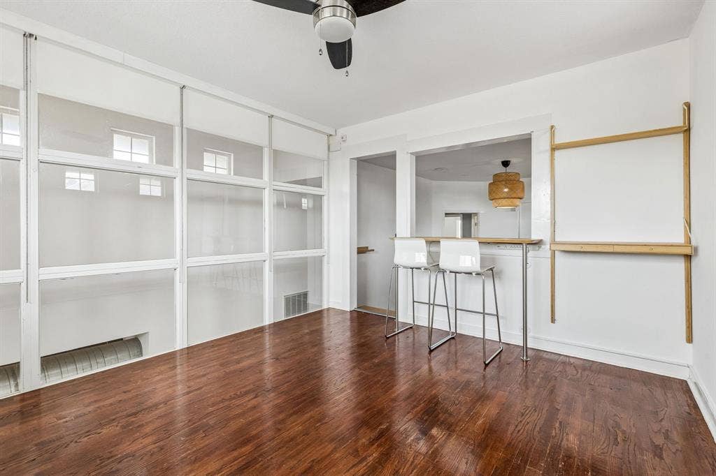 6360 Curtis Street, Plano, TX 75093 Bedroom 2 up with wall of glass with blinds and built in dry bar.