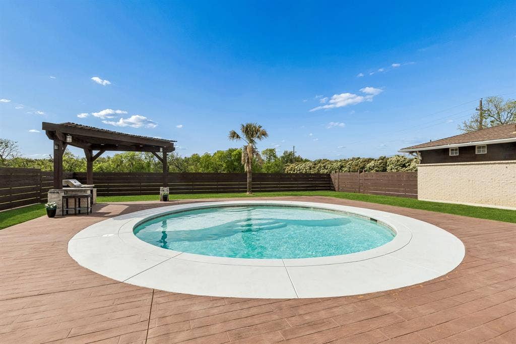 6360 Curtis Street, Plano, TX 75093 Close up view of the pool and the wood look stained concrete decking.