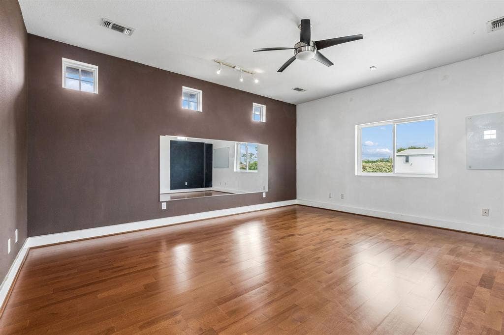 6360 Curtis Street, Plano, TX 75093 Large bonus room with separate staircase. This could have a pool table, work out equipment or a combo. It has wood flooring.