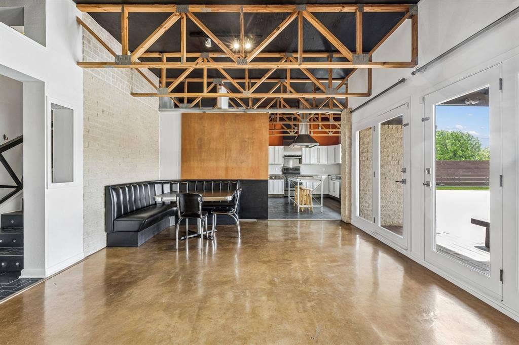 6360 Curtis Street, Plano, TX 75093 Cafe style corner custom built in breakfast nook table. Large barn door then kitchen.