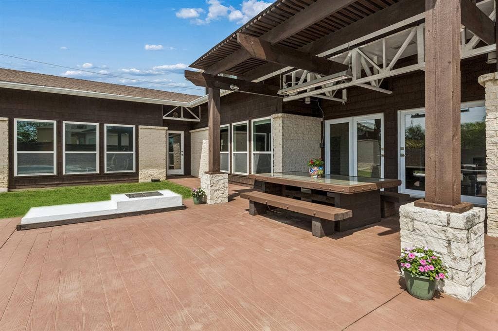 6360 Curtis Street, Plano, TX 75093 Outdoor fire pit with grill cover by the back patio.